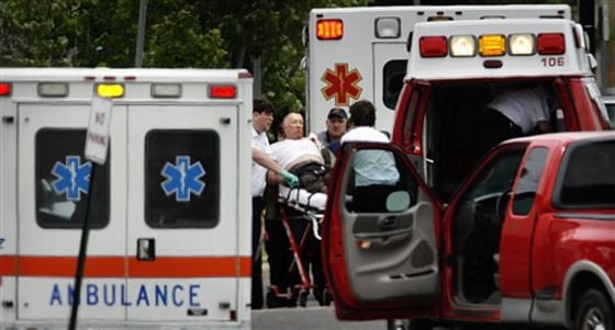 Emergency personel tend to Crittenden County, Ark., Sheriff Dick Busby in the parking lot of a Walmart in West Memphis, Ark.